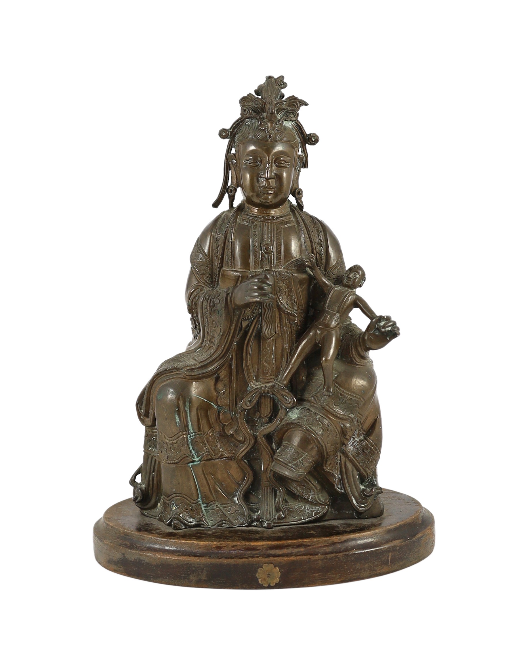 A large Chinese bronze group of Xi Wangmu and a child, late Ming dynasty, 31.5cm high excluding later wood stand